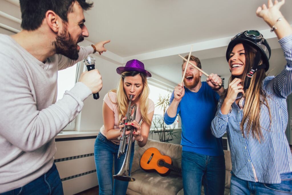 Group Of Friends Playing Karaoke At Home